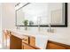 Bright bathroom features a double sink vanity and large mirror and a walk-in shower at 7316 Childers Ave, Las Vegas, NV 89178