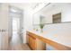 Bright bathroom features a single vanity, modern fixtures, and natural wood trim at 7316 Childers Ave, Las Vegas, NV 89178
