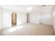 Spacious bedroom boasts neutral carpet, base trim, and an archway leading to another room at 7316 Childers Ave, Las Vegas, NV 89178