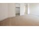 Bright bedroom with beige carpet, view of a closet, and a doorway at 7316 Childers Ave, Las Vegas, NV 89178