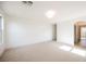 Open bonus room with beige carpet and neutral paint; archway visible at 7316 Childers Ave, Las Vegas, NV 89178