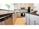 The modern kitchen features grey cabinets, black countertops, and stainless steel appliances at 7316 Childers Ave, Las Vegas, NV 89178