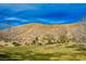 Rolling hillside in Mountain's Edge community under blue sky at 7316 Childers Ave, Las Vegas, NV 89178