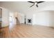 Open concept living room with fireplace and stairs has lots of natural light and light wood floors at 7316 Childers Ave, Las Vegas, NV 89178