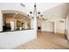 Open concept living space with modern chandelier lighting adjoining the kitchen and dining areas at 7316 Childers Ave, Las Vegas, NV 89178