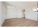 Bright living area showcasing a contemporary chandelier, curved walls, and staircase access at 7316 Childers Ave, Las Vegas, NV 89178