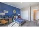 Comfortable bedroom featuring a blue accent wall, dedicated workspace, and ample natural light at 7705 Serenity Bay Ln # Lot 57, North Las Vegas, NV 89084