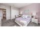 Cozy bedroom with a stylish desk area, comfortable bed, and plenty of natural light from a window at 7705 Serenity Bay Ln # Lot 57, North Las Vegas, NV 89084