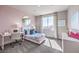 Charming bedroom with soft pink walls, modern furniture, and a large window for plenty of light at 7705 Serenity Bay Ln # Lot 57, North Las Vegas, NV 89084