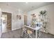Bright home office with a gray carpet, stylish desk, decor, and shelves for storage and design at 7705 Serenity Bay Ln # Lot 57, North Las Vegas, NV 89084