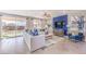 Comfortable living room with plush seating, a ceiling fan, a large window, and a contemporary entertainment center at 7705 Serenity Bay Ln # Lot 57, North Las Vegas, NV 89084