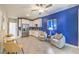 Open floor plan with kitchenette, stainless steel fridge, seating area, and modern finishes at 7705 Serenity Bay Ln # Lot 57, North Las Vegas, NV 89084