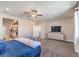 Bright main bedroom boasts a large window, comfortable bed, and a view into the ensuite bathroom with dual sinks at 7705 Serenity Bay Ln # Lot 57, North Las Vegas, NV 89084