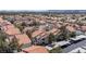 A bird's eye view of a charming neighborhood featuring tidy rooftops, abundant trees, and covered parking areas at 7905 Idledale Ct # 102, Las Vegas, NV 89145