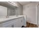 Well lit bathroom featuring double sinks, a large mirror and shower at 7905 Idledale Ct # 102, Las Vegas, NV 89145