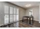 Dining area with wood flooring, plantation shutters, and views of the kitchen at 7905 Idledale Ct # 102, Las Vegas, NV 89145