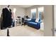 Well-lit bedroom featuring a blue sofa, desk, and hardwood floors at 8060 Haywood Estate Ave, Las Vegas, NV 89113