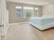 Bright bedroom with a large window, wood floors, and a simple modern bed frame at 8060 Haywood Estate Ave, Las Vegas, NV 89113