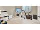 Bonus room area featuring exercise bike, TV, and storage with wood-style flooring and neutral walls at 8060 Haywood Estate Ave, Las Vegas, NV 89113