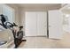 Bonus room area featuring exercise bike with closet and door with light wood-style flooring at 8060 Haywood Estate Ave, Las Vegas, NV 89113