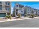 View of a modern three-story townhome with unique round window and blue skies at 8060 Haywood Estate Ave, Las Vegas, NV 89113