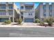 Modern three-story townhome with unique round window and well maintained landscaping at 8060 Haywood Estate Ave, Las Vegas, NV 89113