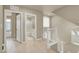 Hallway view with wood floors, white trim, and a bathroom visible through a doorway at 8060 Haywood Estate Ave, Las Vegas, NV 89113