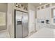 Kitchen with stainless steel refrigerator, white cabinets, and stylish countertop appliances at 8060 Haywood Estate Ave, Las Vegas, NV 89113