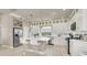 Bright kitchen features white cabinets, stainless steel appliances, and a large island with seating at 8060 Haywood Estate Ave, Las Vegas, NV 89113