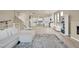 Spacious open-concept living area leading to a modern kitchen, with hardwood floors at 8060 Haywood Estate Ave, Las Vegas, NV 89113