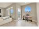 Bright living room with round window, natural light, modern sofa, and hardwood floors at 8060 Haywood Estate Ave, Las Vegas, NV 89113