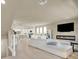 Open-concept living space flows to a modern kitchen, with white sofas and contemporary fireplace at 8060 Haywood Estate Ave, Las Vegas, NV 89113