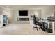 Open living room with hardwood floors and a linear fireplace at 8060 Haywood Estate Ave, Las Vegas, NV 89113