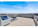 Outdoor lounge features comfortable furniture, blue pillows and skyline views at 8060 Haywood Estate Ave, Las Vegas, NV 89113
