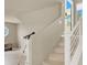 Staircase with metal railing and a view to the front entrance, living room, and telescope at 8060 Haywood Estate Ave, Las Vegas, NV 89113