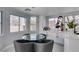 Bright breakfast nook with circular glass table, gray chairs, and built-in bar area with beverage storage at 8150 Beaverbrook Way, Las Vegas, NV 89123