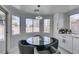 Breakfast nook featuring round table, chairs, and view of backyard from multiple windows at 8150 Beaverbrook Way, Las Vegas, NV 89123