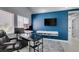 Home office with blue accent wall, modern floating console, and updated black and grey office furniture at 8150 Beaverbrook Way, Las Vegas, NV 89123