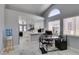 Bright home office with an open view to the kitchen, featuring modern desk and computer setup at 8150 Beaverbrook Way, Las Vegas, NV 89123
