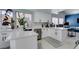 Bright white kitchen featuring modern appliances, stone countertops, and an adjacent work/office area at 8150 Beaverbrook Way, Las Vegas, NV 89123