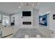 Stylish living room featuring modern fireplace and opens to another room with a blue accent wall at 8150 Beaverbrook Way, Las Vegas, NV 89123