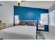 Main bedroom features a bold accent wall, plush bedding, and contemporary nightstands at 8150 Beaverbrook Way, Las Vegas, NV 89123