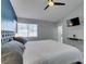 Comfortable main bedroom with a gray upholstered headboard and a wall mounted television at 8150 Beaverbrook Way, Las Vegas, NV 89123