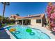 Backyard pool area with a solar-heated pool, lounge chairs, and lush landscaping at 8150 Beaverbrook Way, Las Vegas, NV 89123