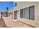 Rear exterior view showing the enclosed patio, windows and rock landscaping at 8233 Willeta Ave, Las Vegas, NV 89145