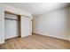 This bedroom has wood-look flooring, a closet with sliding doors and a ceiling mounted light at 8233 Willeta Ave, Las Vegas, NV 89145