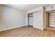 Bedroom with wood-look flooring and closet with sliding doors, plus a view of additional storage shelves at 8233 Willeta Ave, Las Vegas, NV 89145
