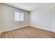 Bright bedroom featuring wood-look flooring and a window with light-filtering blinds at 8233 Willeta Ave, Las Vegas, NV 89145
