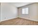 Bright bedroom with wood flooring, a large window, and neutral walls at 8233 Willeta Ave, Las Vegas, NV 89145