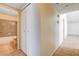 Hallway with beige tile floor, linen closet and a view into the bathroom at 8233 Willeta Ave, Las Vegas, NV 89145